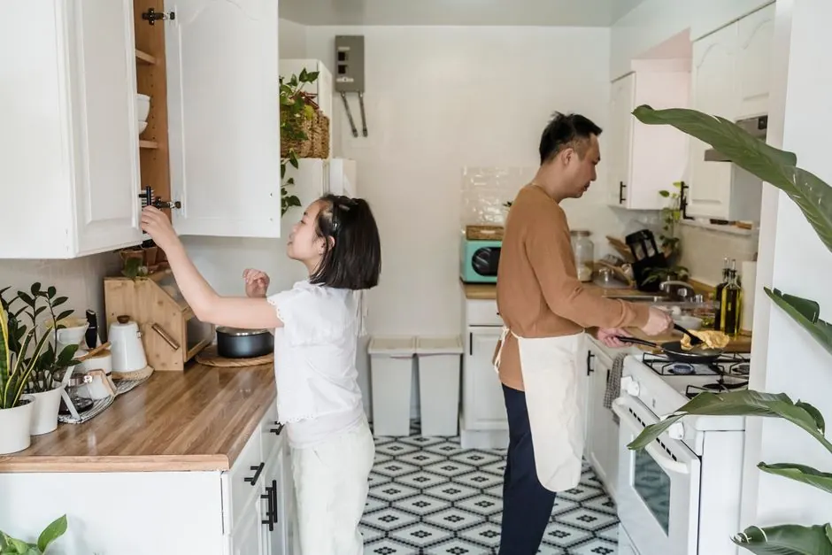 A family cooking together in a bright, modern kitchen, fostering togetherness.